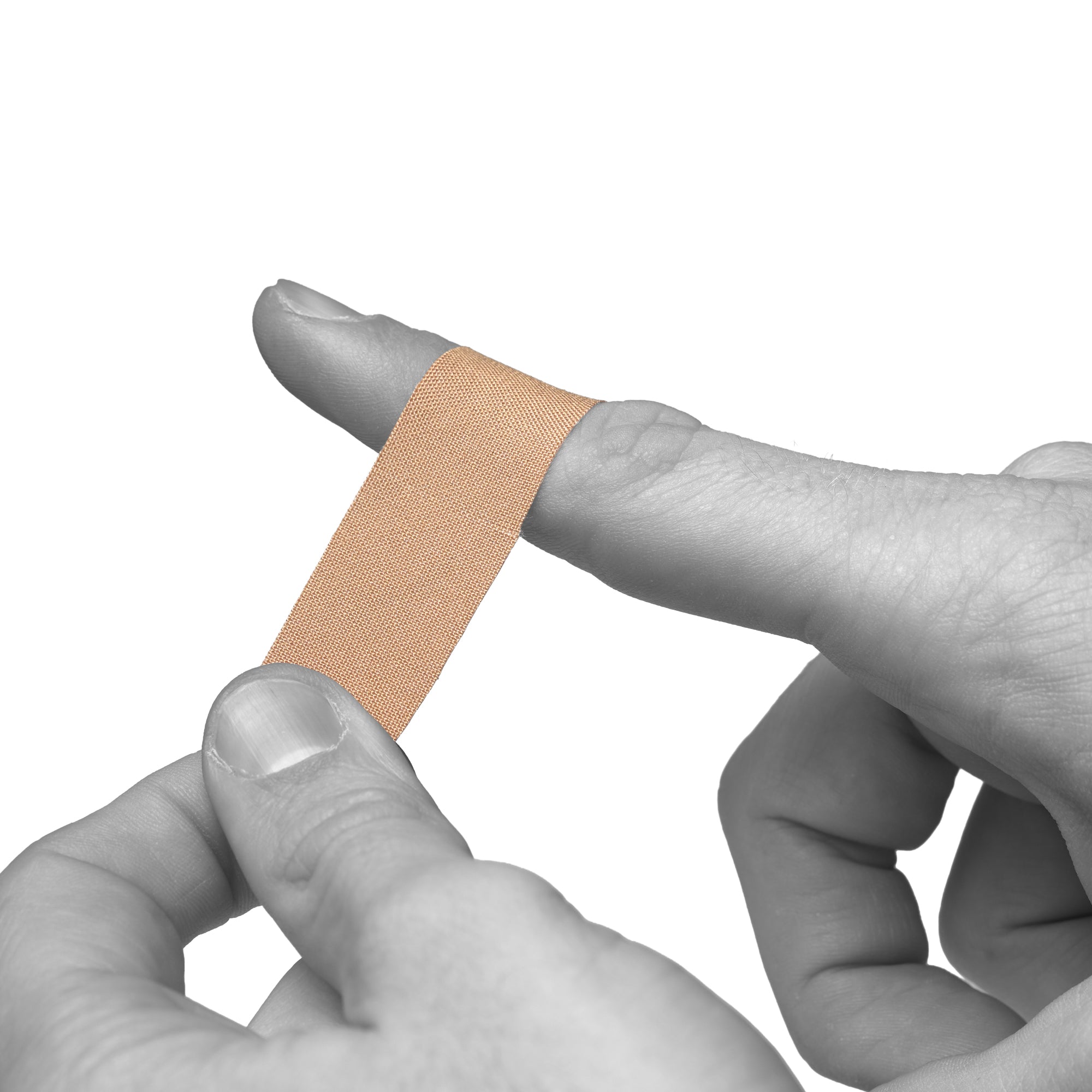 A beige adhesive bandage being applied to a finger, shown against a plain white background with a grayscale hand holding the bandage in place.